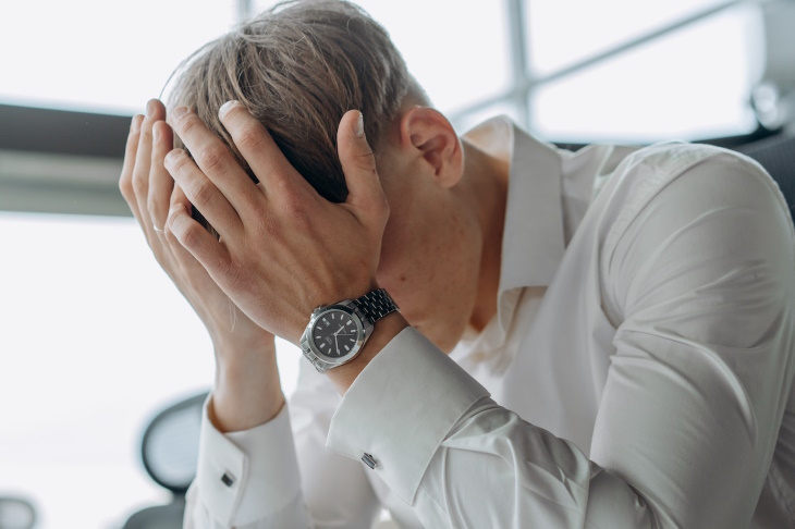 Burnout Recovery man covering head