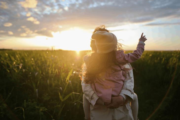 adult and child in a field