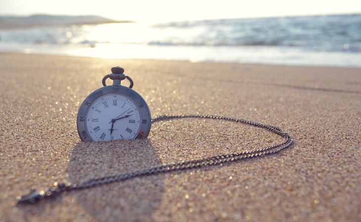 clock in the sand on a beach