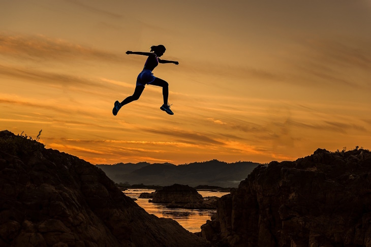 Famous Paradoxes woman jumping over a hill