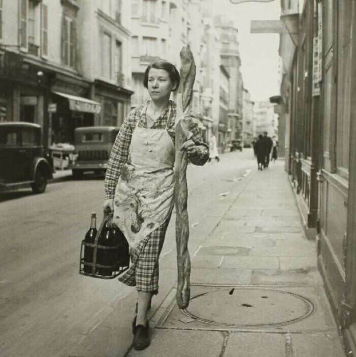 Historical Photos "A French Woman With Her Baguette And Six Bottles Of Wine, Paris, France, 1945"
