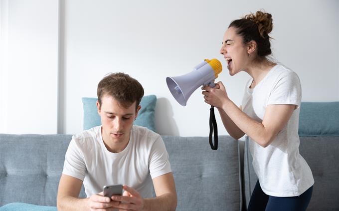 Toxic relationship test: A woman yells at a man with a megaphone