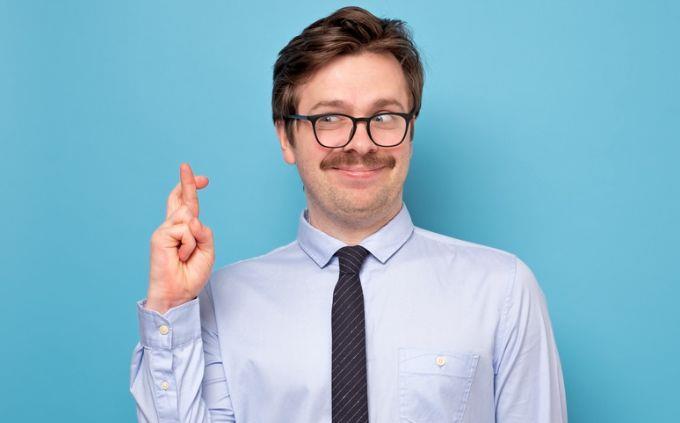 Are you a liar: Man holding up fingers and smiling