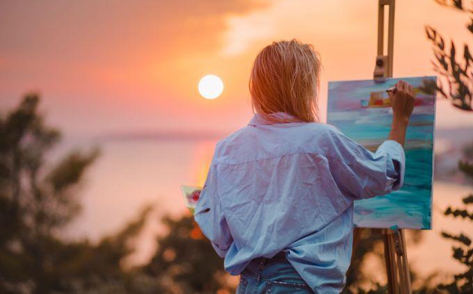 Which planet matches your personality: Woman painting in front of a sunset