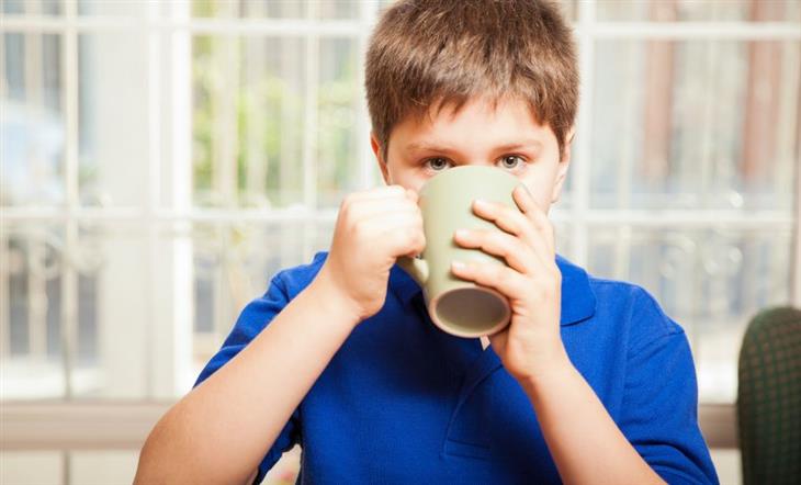 boy drinking from a cup