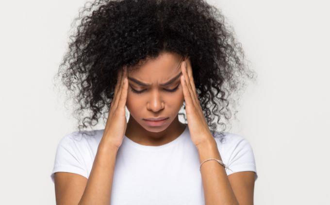 Are you worn out or stressed: a woman holding her head
