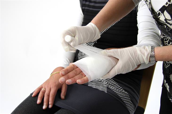 woman applying bandage to hand