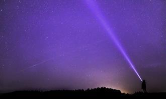 Suprasensory perception test: A flashlight illuminates the night sky
