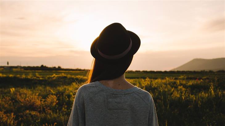 how to stop pleasing others woman with hat in a field