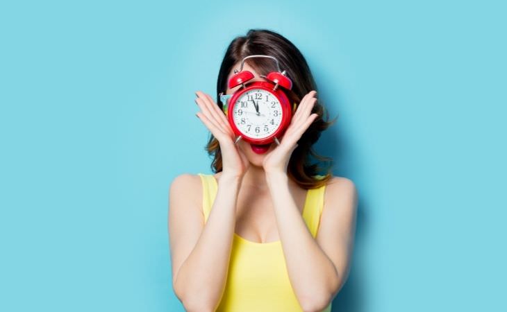 Mistakes you'll regret in the future: woman with clock in front of her face