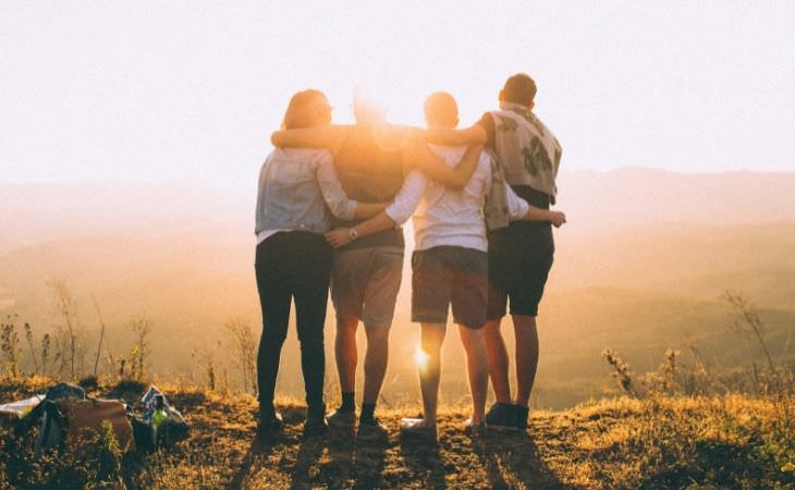 Mistakes you'll regret in the future: friends hugging on a cliff