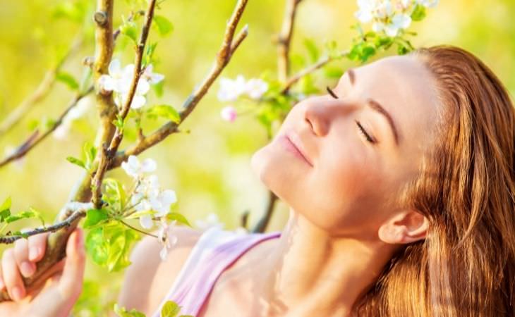 Mistakes you'll regret in the future: woman facing a flowering tree