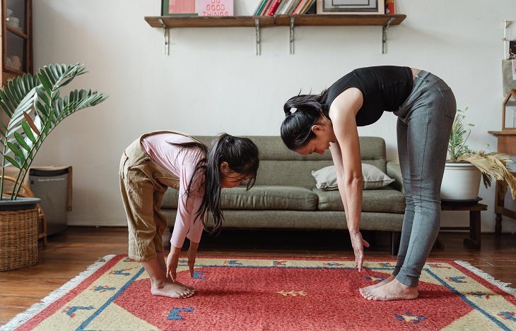 Meditation with kids: Mother and daughter meditating