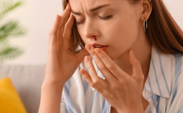 Causes, Treatment, and Prevention for Nosebleeds: Woman with a Nosebleed