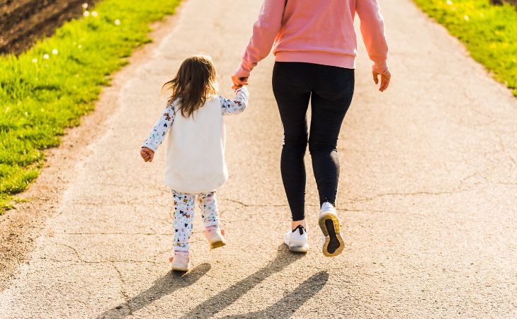 Important lessons to teach children: A child walking alongside her mother