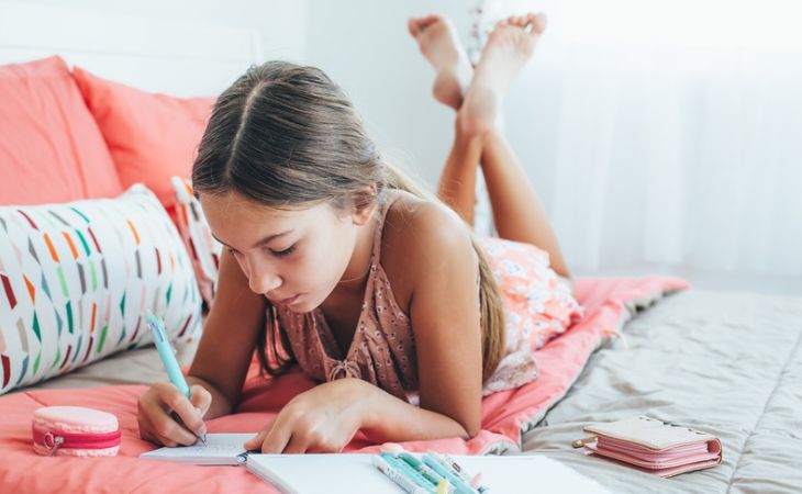 Important lessons to teach children: A girl writing in a journal