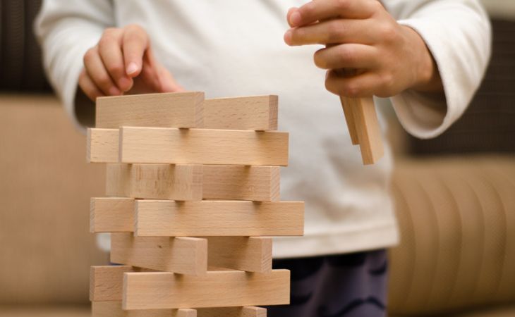 Important lessons to teach children: A child building a tower of blocks