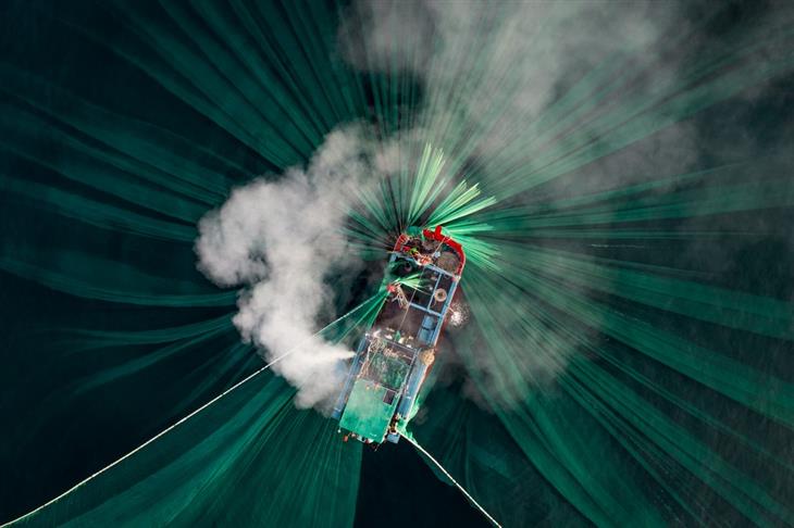 2024 Ocean Photographer competition photos: drone shot of fishing boat with smoke stack