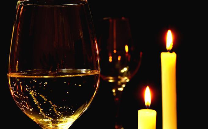 Flowers and romance test: candles and a glass of wine