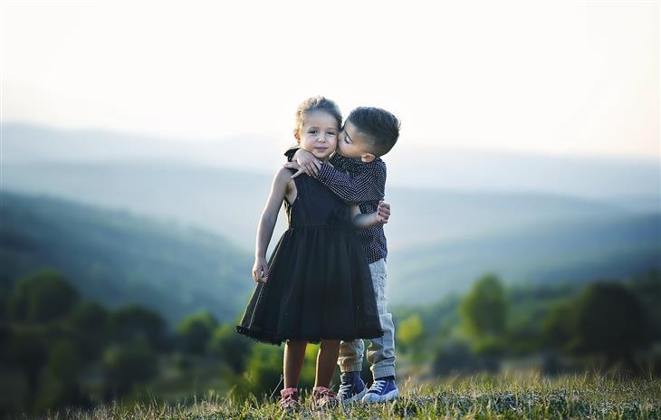 Things to teach children about love: a boy kisses a girl