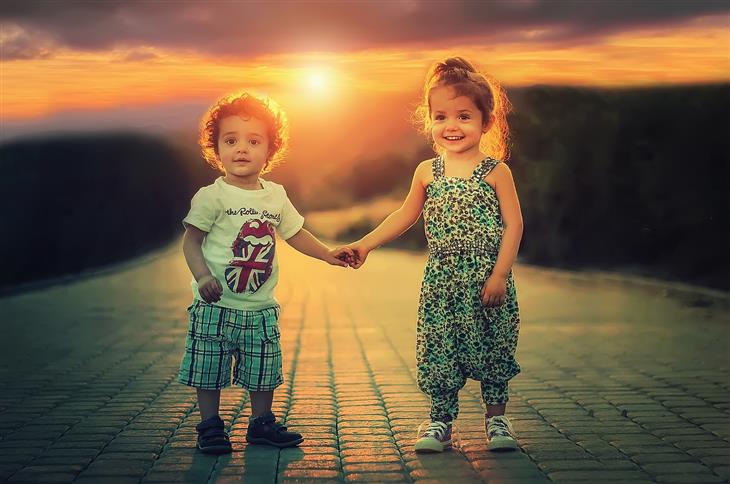 Things to teach children about love: a boy and girl holding hands