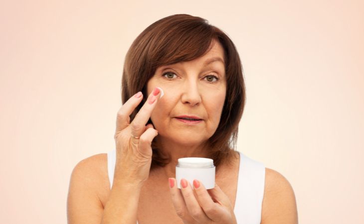 Skincare by Age: Woman Applying Cream to Face