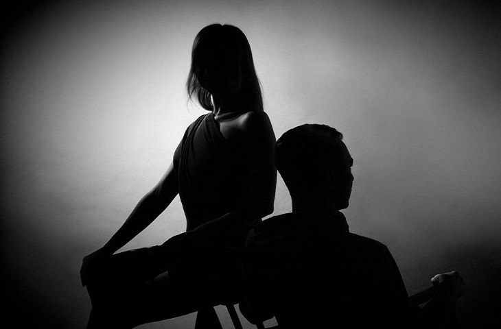 Holding Grudges in Relationships: Silhouettes of a Man and Woman Facing Away from Each Other