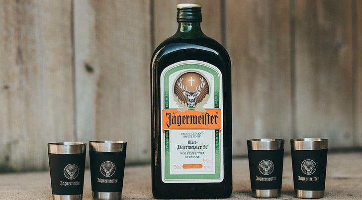 Health benefits of alcoholic beverages: Jägermeister bottle beside shot glasses