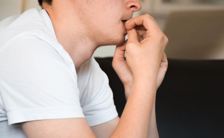 The difference between anxiety and panic attacks: A person biting nails