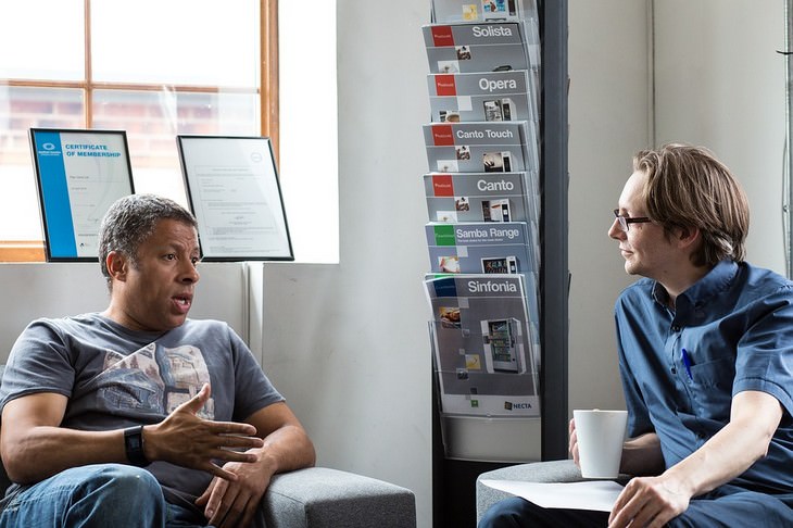 A man talking while another man listens