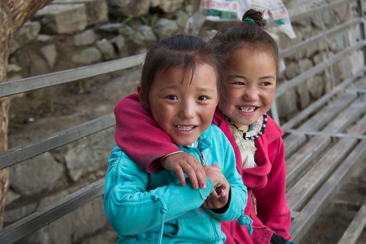 4 Stages of Raising Children According to the Tibetans: Two Smiling Tibetan Girls