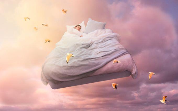 Where will you be in 5 years according to your dreams: a woman sleeping in a bed flying in the sky