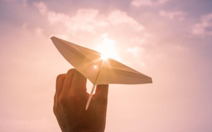 Where will you be in 5 years according to your dreams: A hand holding a paper airplane