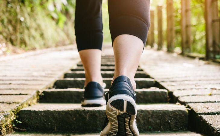 legs of woman going up stairs outside