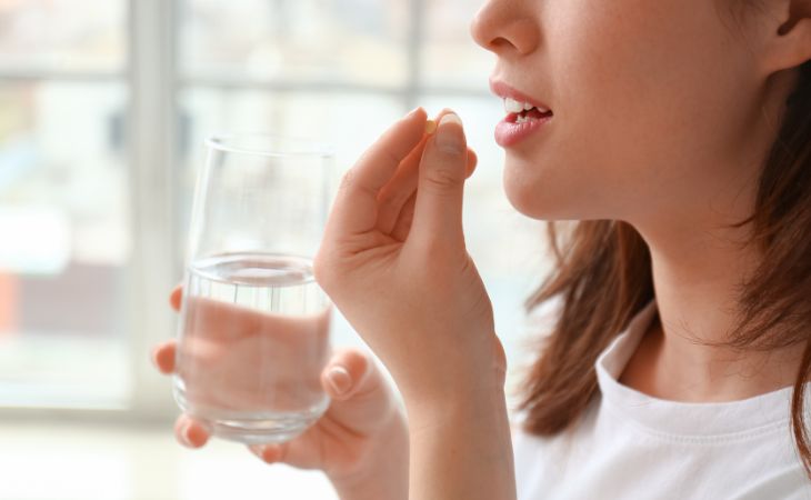 woman taking a pill