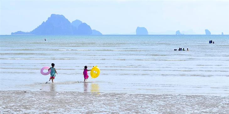 kids playing on the beach in thailand