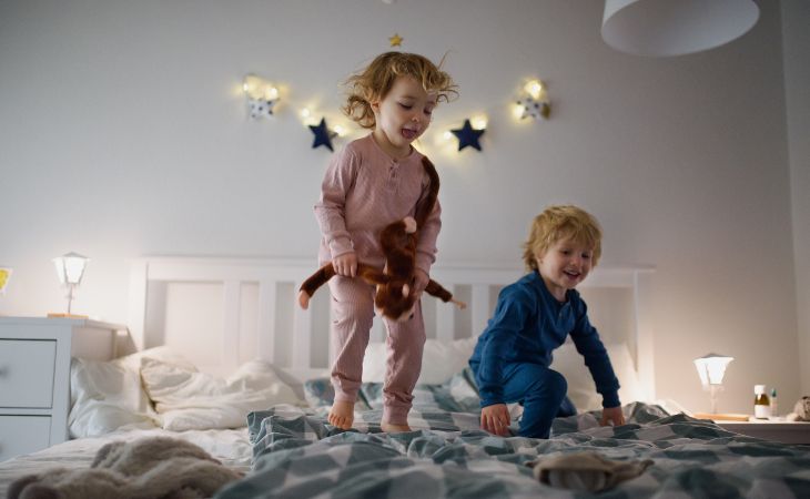 toddlers jumping on the bed