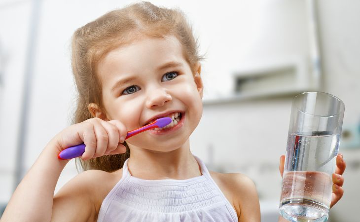 little girl brushing her teeth