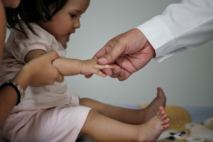 Child skin problems: A doctor holding the hand of a toddler