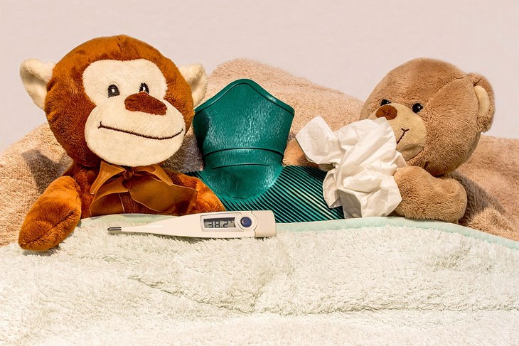 Child skin problems: Toys covered with a blanket next to a thermometer and a bottle of cold water