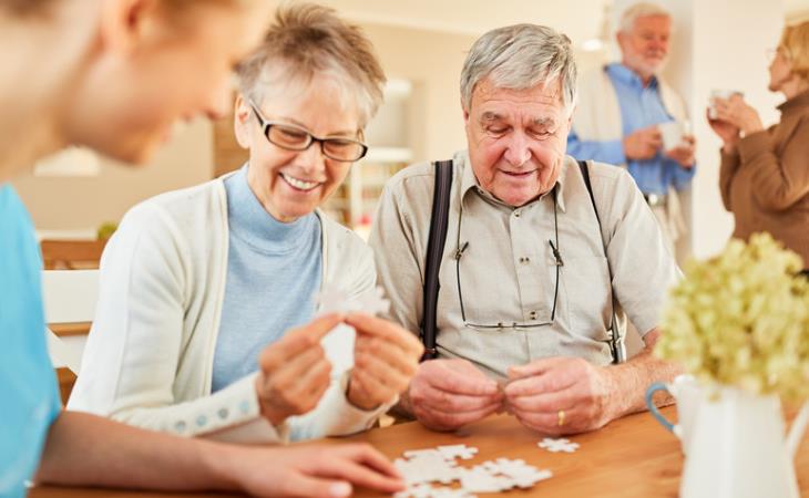 New molecule for Alzheimer's treatment: elderly people assembling a puzzle