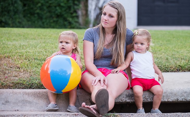 Things not to be ashamed of and hide from a therapist: A woman with two children and a pensive look