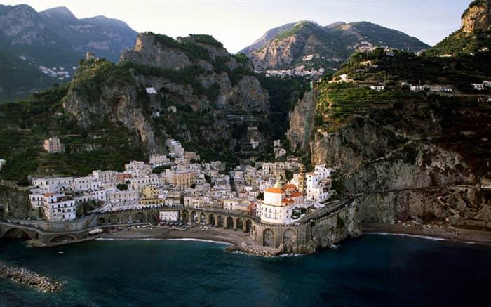 The Amalfi Coast in Italy: Cliffs with vegetation and houses overlooking the sea