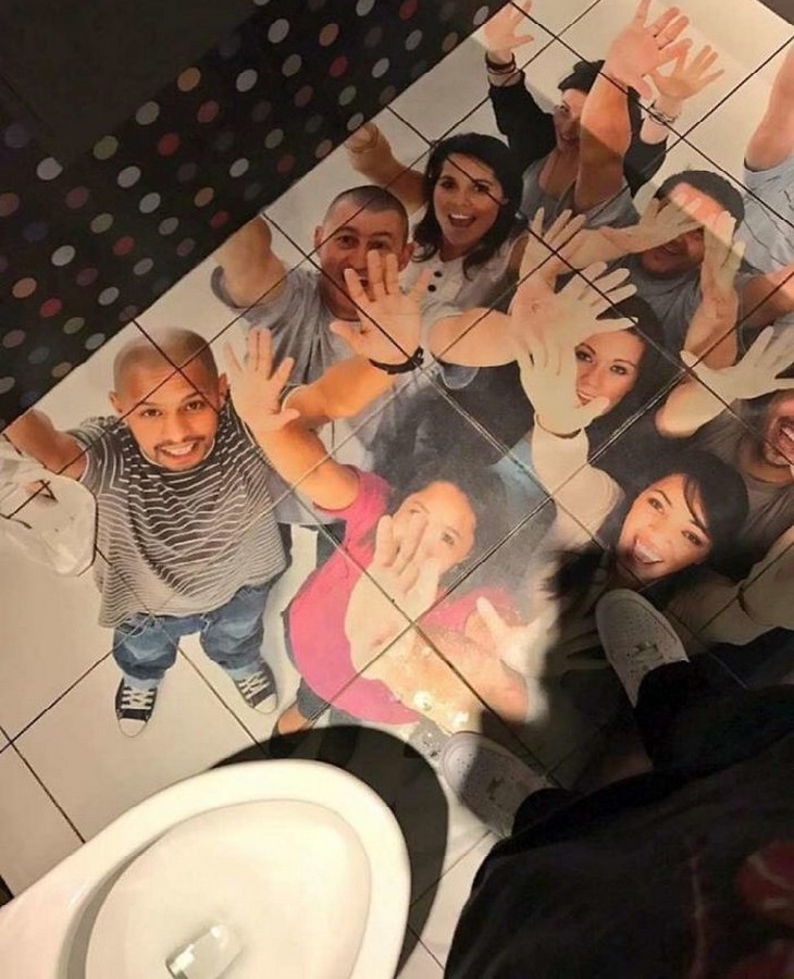 Bizarre Toilets: A toilet stall with wallpaper of a crowd of people