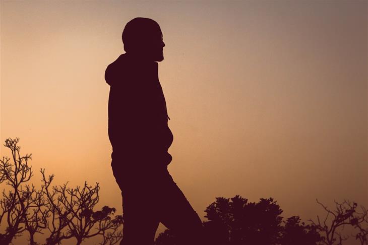 How to Overcome the Fear of Disappointing Others: Silhouette of a person in nature at twilight