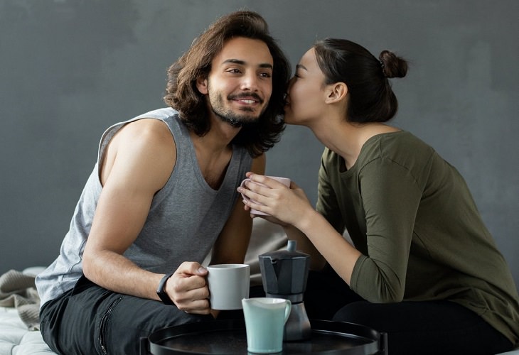 Questions for a Better Relationship: Woman whispering in a man's ear