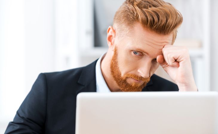 Shiny object syndrome: Frustrated man in front of computer