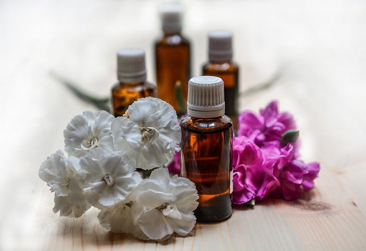 Uses of eucalyptus oil: Oil bottles alongside flowers