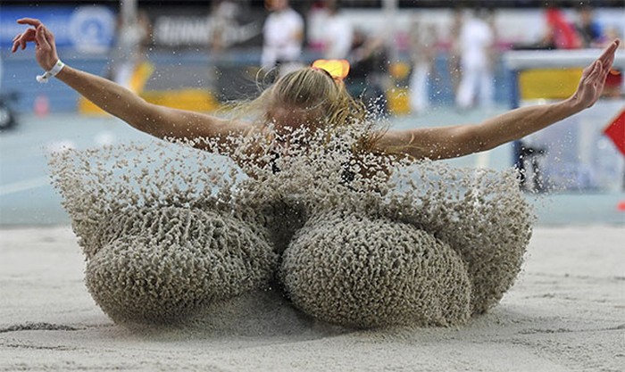 Funny perfectly timed photos: perfect landing moment for long jumper