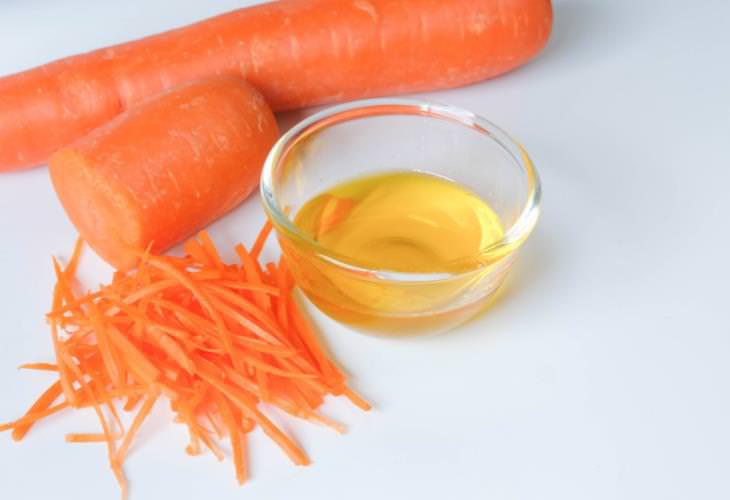 How to make carrot oil and recommended uses: Carrots next to a bowl of oil